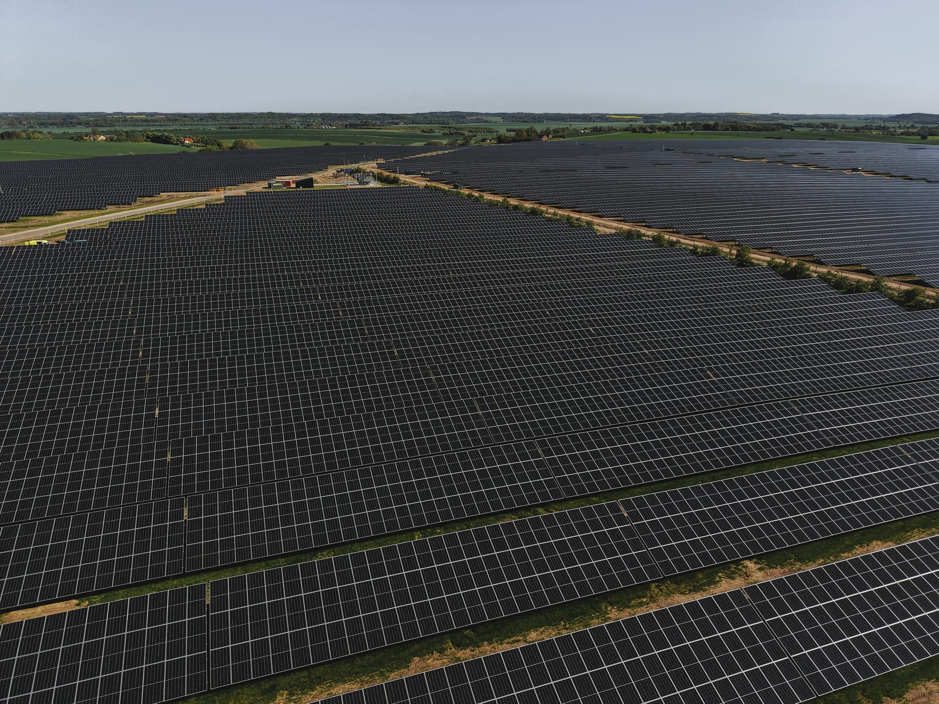 Aerial view of a completed utility-scale solar PV farm in the Danish countryside